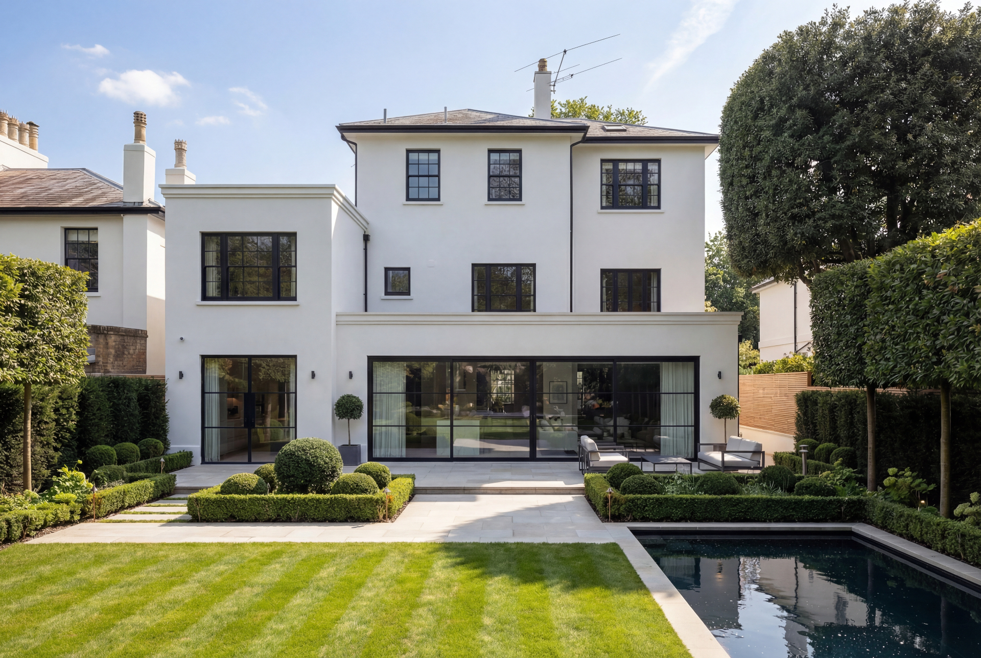 Stunning London home extension with bi-fold doors opening to a sunlit garden